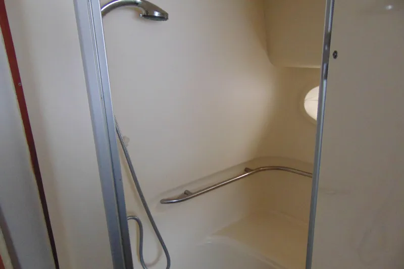 Slide: The Image of Shower area in 1999 Maxum 4100 SCA boat with handheld showerhead and grab bar. - 9