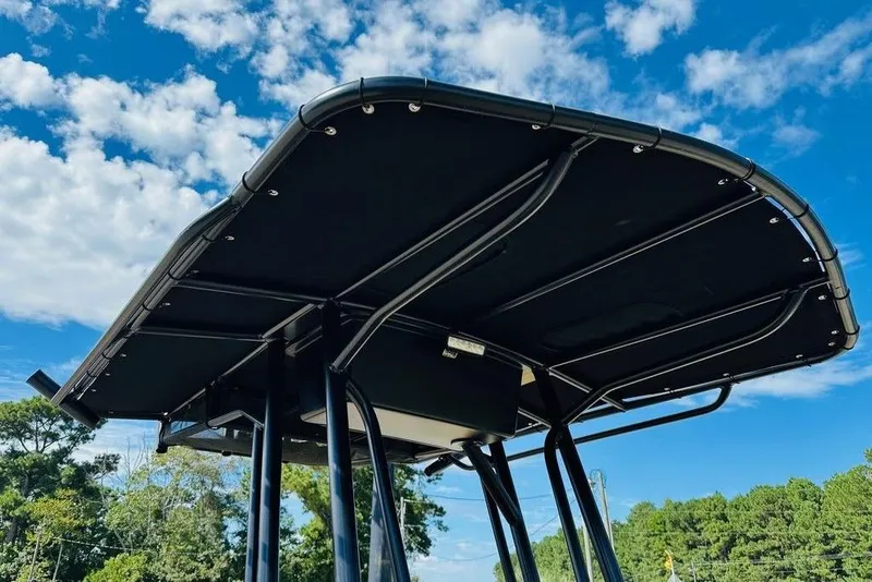 Slide: The Image of 2024 War Eagle 2170 Blackhawk boat canopy against a blue sky with clouds. - 1
