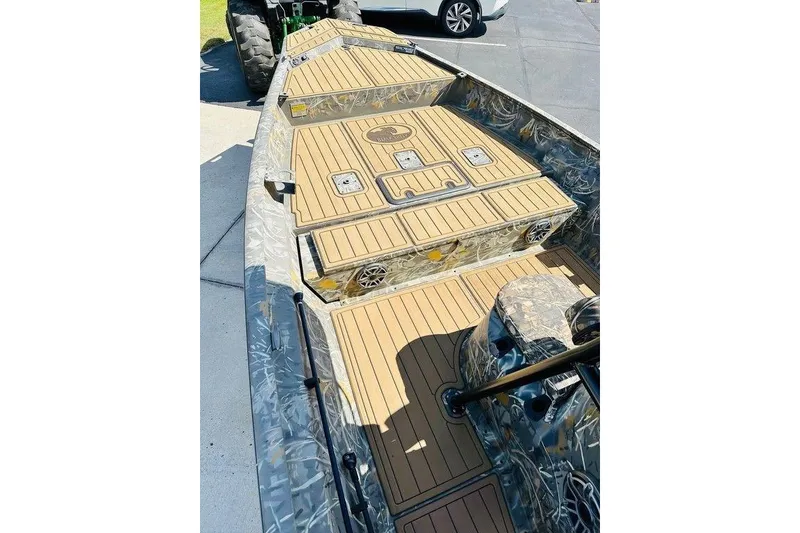 Slide: The Image of 2024 War Eagle 2170 Blackhawk boat with camo design and spacious deck layout. - 3