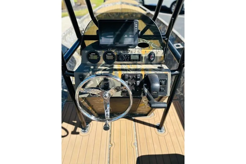 Slide: The Image of 2024 War Eagle 2170 Blackhawk boat console with steering wheel and controls. - 5