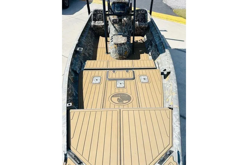 Slide: The Image of 2024 War Eagle 2170 Blackhawk boat with camo seats and tan deck flooring. - 6