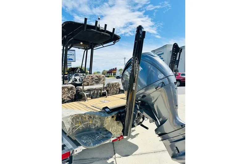 Slide: The Image of 2024 War Eagle 2170 Blackhawk boat with powerful outboard motor, camo seats, and sunny sky backdrop. - 7