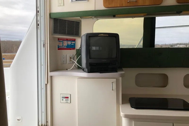 Slide: The Image of Interior of 1994 Mainship 31 Sedan Bridge with vintage TV and countertop. - 12