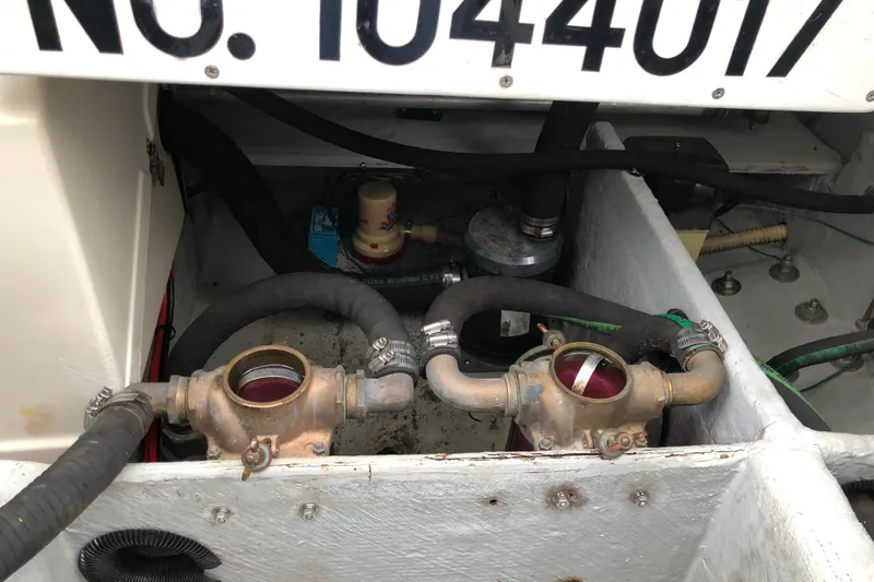 Slide: The Image of Engine compartment of a 1994 Mainship 31 Sedan Bridge with visible hoses and components. - 20