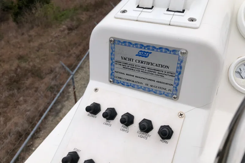 Slide: The Image of Control panel of a 1994 Mainship 31 Sedan Bridge with yacht certification plaque. - 7