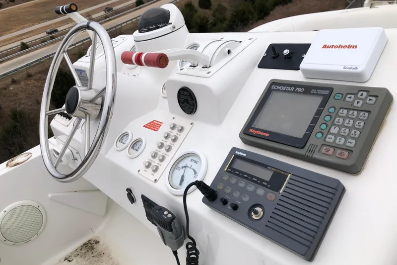 Slide: The Image of 1994 Mainship 31 Sedan Bridge helm with steering wheel, gauges, and navigation equipment. - 8