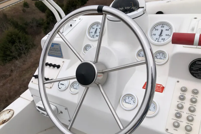 Slide: The Image of Steering wheel and dashboard of 1994 Mainship 31 Sedan Bridge boat. - 9