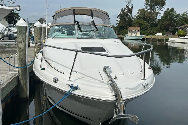 The Image of 2001 Sea Ray 270 Sundancer docked at marina, front view with anchor and canopy. - 0
