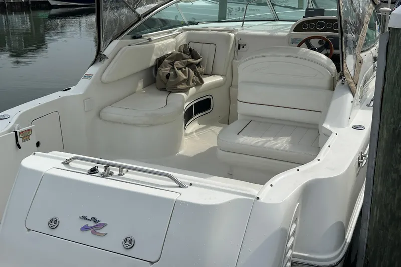 Slide: The Image of 2001 Sea Ray 270 Sundancer boat interior with white seating and dashboard. - 1