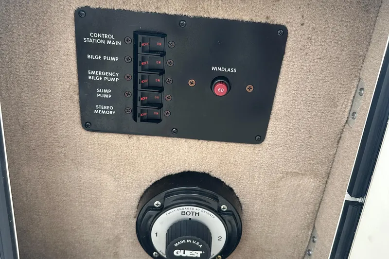 Slide: The Image of Control panel of a 2001 Sea Ray 270 Sundancer boat with switches and windlass control. - 11
