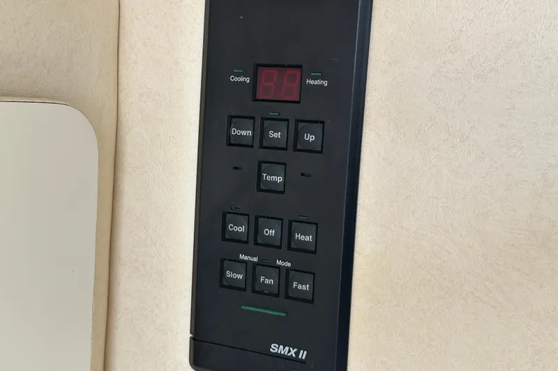 Slide: The Image of Control panel of a 2001 Sea Ray 270 Sundancer boat, featuring temperature settings. - 12