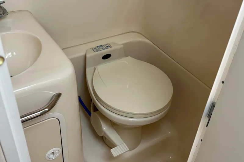 Slide: The Image of 2001 Sea Ray 270 Sundancer boat bathroom with toilet and sink. - 17
