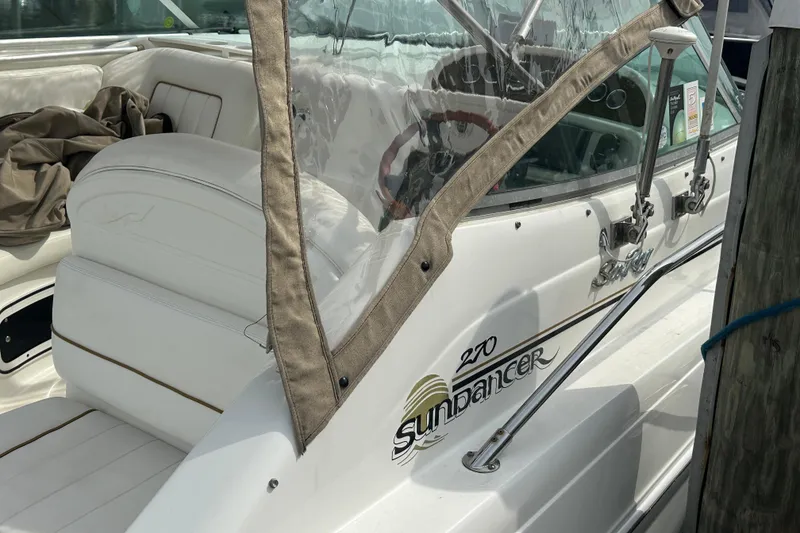 Slide: The Image of 2001 Sea Ray 270 Sundancer boat with white seating and clear canopy. - 2