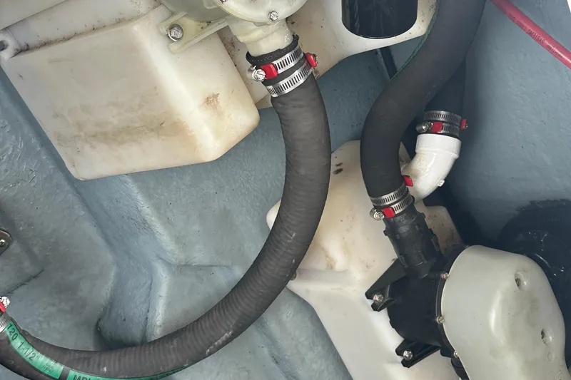 Slide: The Image of Engine compartment of 2001 Sea Ray 270 Sundancer with hoses and clamps visible. - 24