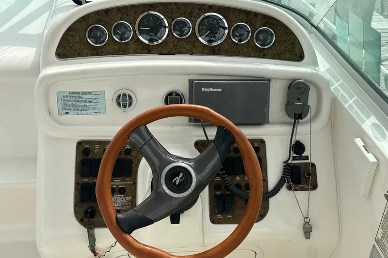 Slide: The Image of 2001 Sea Ray 270 Sundancer helm with wood steering wheel and instrument panel. - 4
