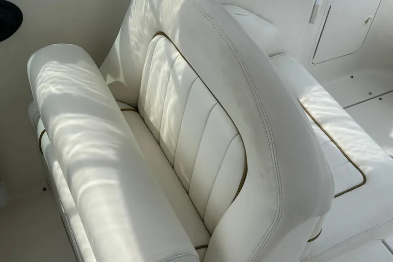 Slide: The Image of White leather seating on a 2001 Sea Ray 270 Sundancer boat interior. - 6