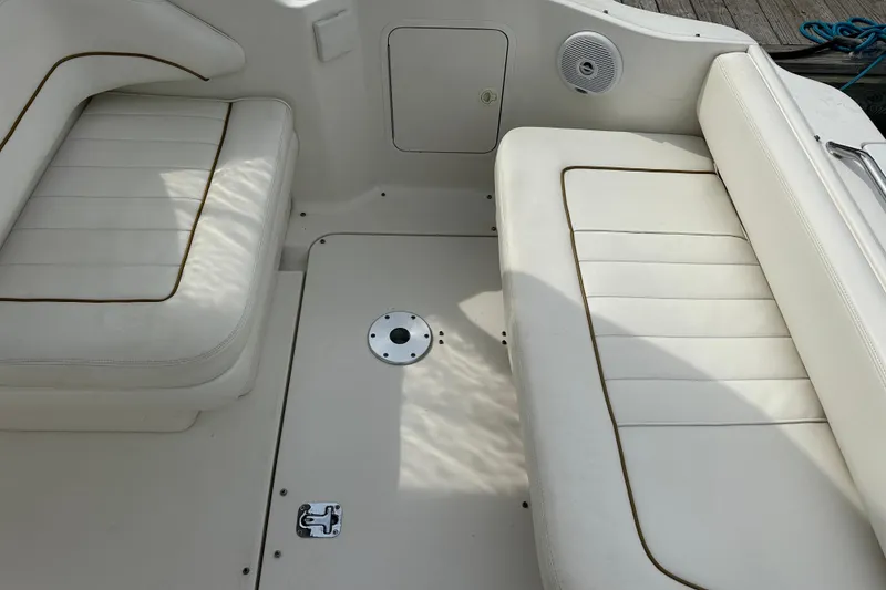Slide: The Image of 2001 Sea Ray 270 Sundancer interior seating with white upholstery and deck details. - 7