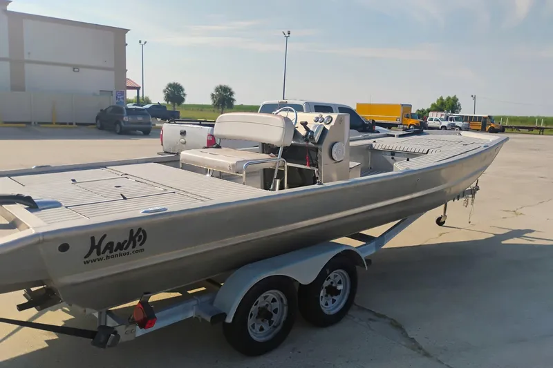 Slide: The Image of Hanko 20 SC 2010 boat on trailer in parking lot, sunny day. - 3