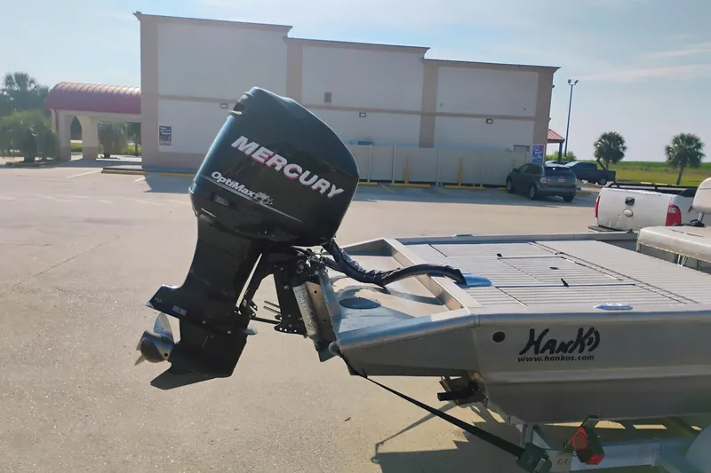 Slide: The Image of 2010 Hanko 20 SC boat with Mercury OptiMax engine in a parking lot. - 4