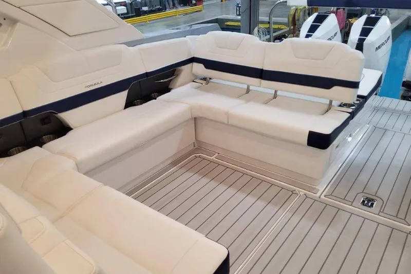 Slide: The Image of 2026 Formula 400 Super Sport Crossover interior with seating and table in a showroom. - 16