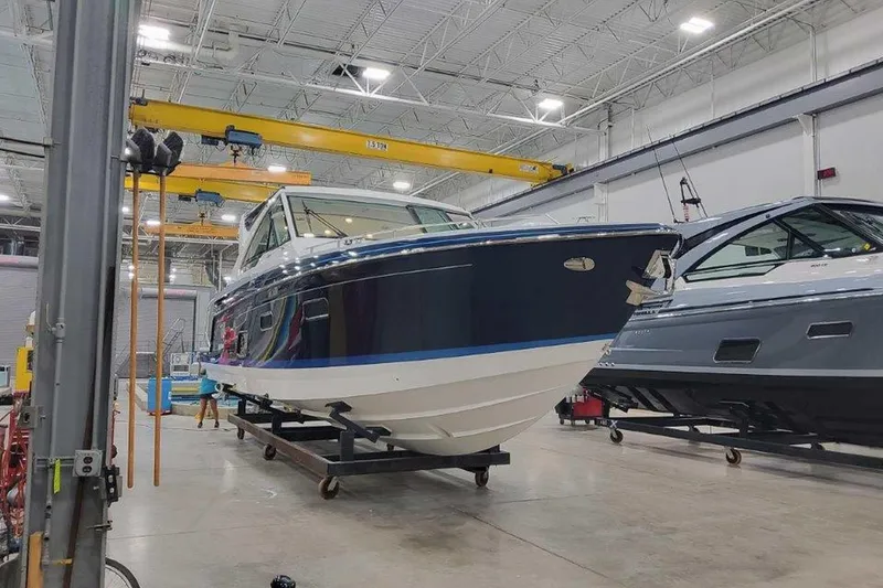 Slide: The Image of 2026 Formula 400 Super Sport Crossover boat in a modern indoor facility. - 2
