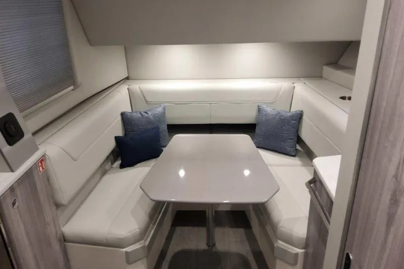 Slide: The Image of 2026 Formula 400 Super Sport Crossover boat interior with white seating and table. - 25