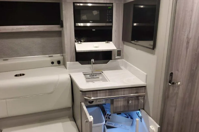 Slide: The Image of 2026 Formula 400 Super Sport Crossover anchor compartment with winch and storage. - 30