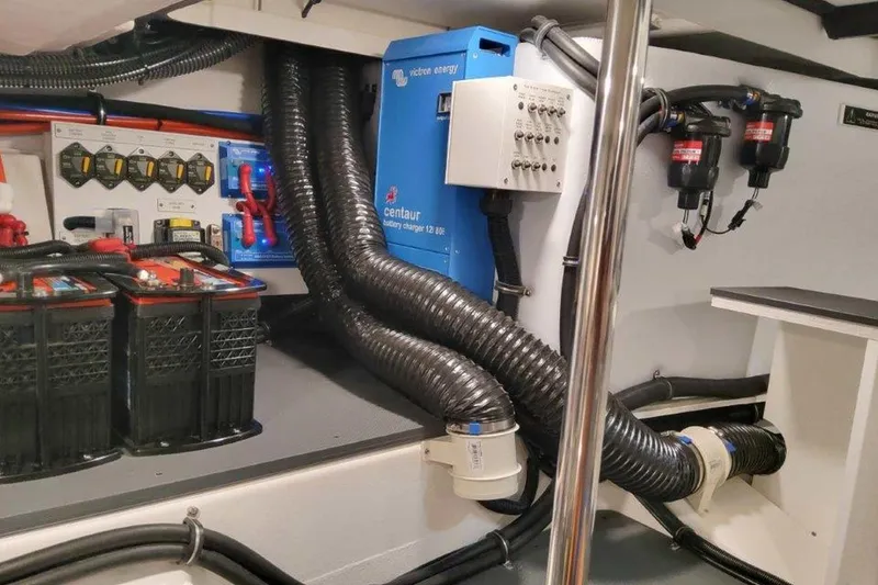 Slide: The Image of Electrical components and blue ducting inside a 2026 Formula 400 Super Sport Crossover. - 54