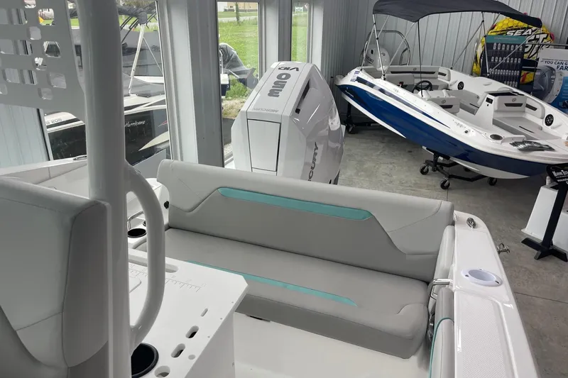 Slide: The Image of 2026 Hurricane Center Console 24 OB boat interior with seating and outboard motor. - 13
