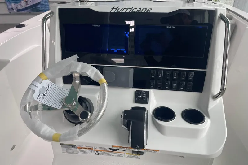 Slide: The Image of 2026 Hurricane Center Console 24 OB boat dashboard with steering wheel and control panel. - 21