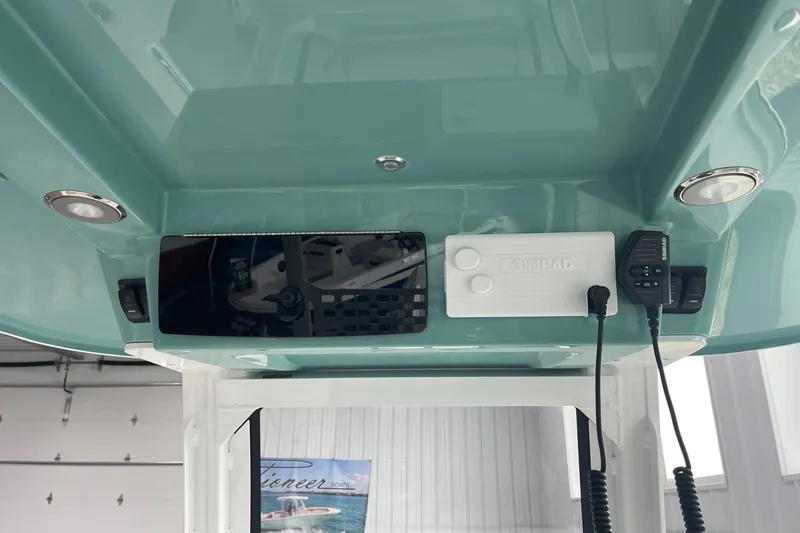 Slide: The Image of 2026 Hurricane Center Console 24 OB boat dashboard with Simrad electronics and communication devices. - 22