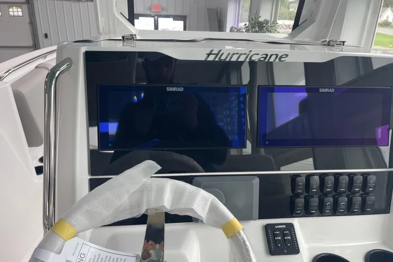 Slide: The Image of 2026 Hurricane Center Console 24 OB dashboard with dual Simrad displays and control panel. - 24