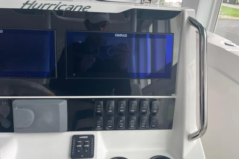 Slide: The Image of 2026 Hurricane Center Console 24 OB dashboard with Simrad displays and control panel. - 25