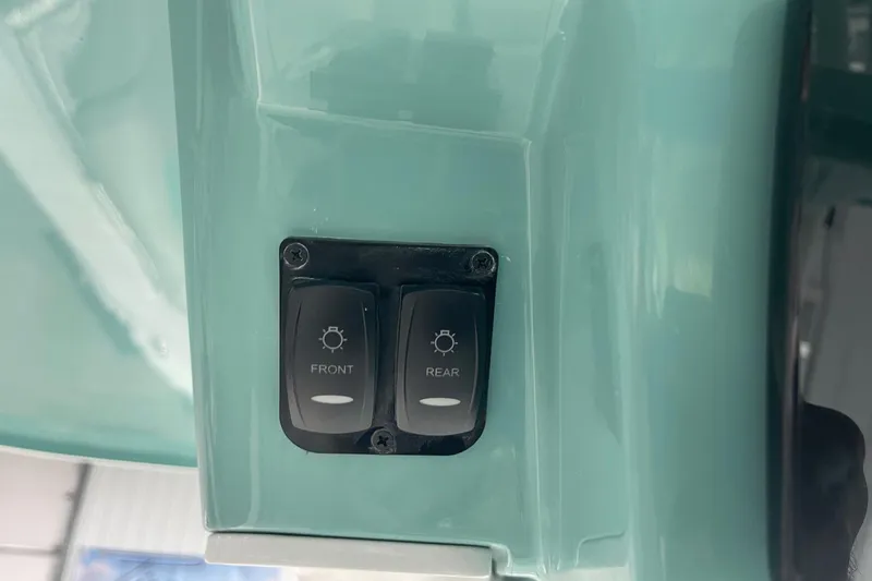 Slide: The Image of Switch panel on 2026 Hurricane Center Console 24 OB boat, featuring front and rear light controls. - 28