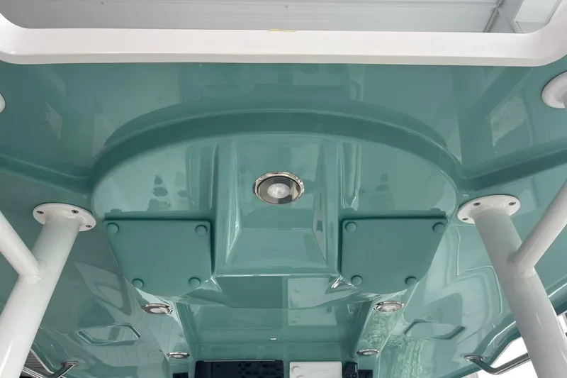 Slide: The Image of 2026 Hurricane Center Console 24 OB boat, teal underside view with structural details. - 32