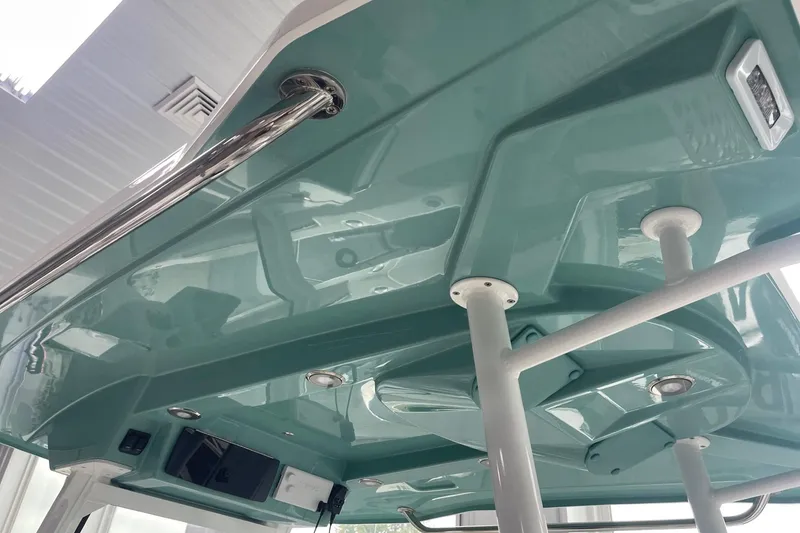 Slide: The Image of 2026 Hurricane Center Console 24 OB boat's sleek interior roof design with stainless steel accents. - 34