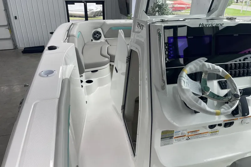 Slide: The Image of 2026 Hurricane Center Console 24 OB boat interior with steering wheel and seating. - 37