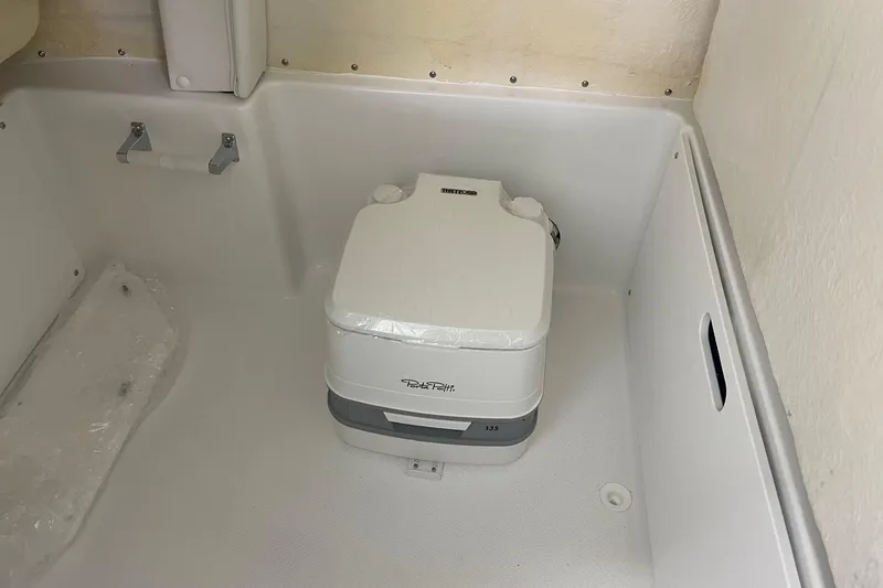 Slide: The Image of Portable toilet inside 2026 Hurricane Center Console 24 OB boat cabin. - 39