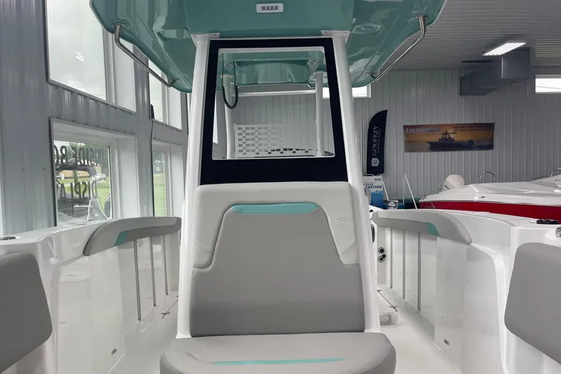 Slide: The Image of 2026 Hurricane Center Console 24 OB boat interior in showroom, featuring modern seating and design. - 42