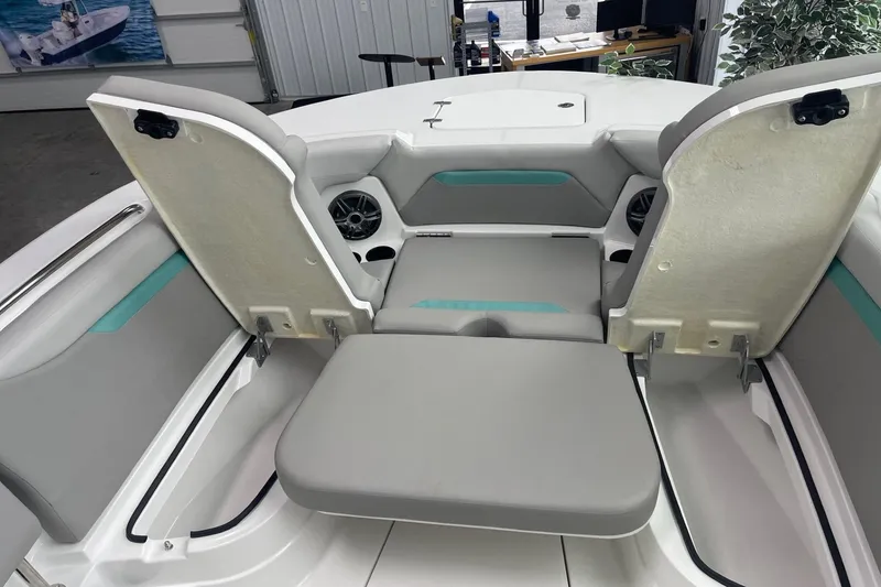 Slide: The Image of 2026 Hurricane Center Console 24 OB boat interior with gray seating and storage compartments. - 45