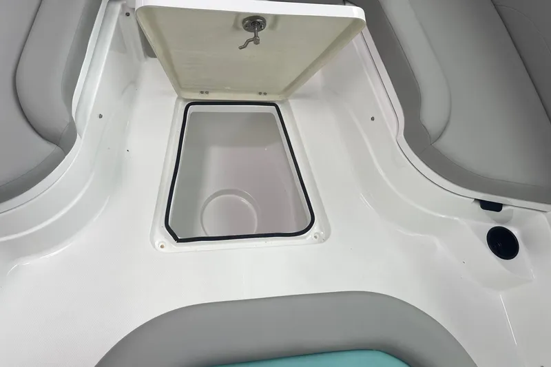 Slide: The Image of 2026 Hurricane Center Console 24 OB boat storage compartment, open lid, white interior. - 46