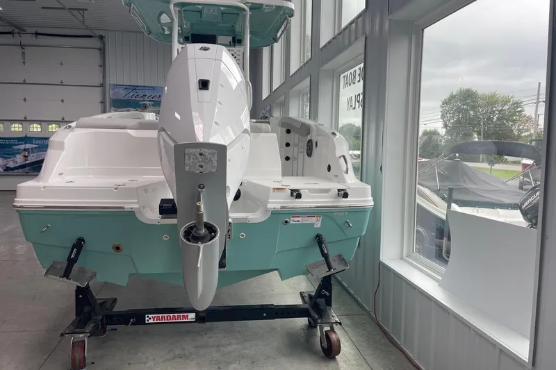 Slide: The Image of 2026 Hurricane Center Console 24 OB boat displayed indoors, rear view. - 6