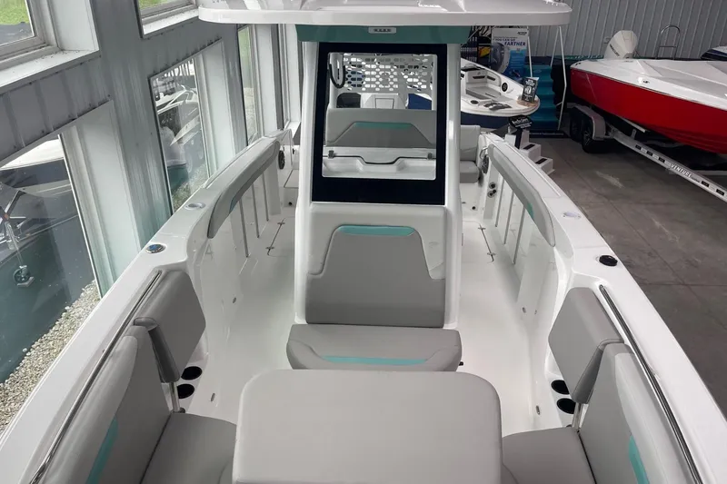 Slide: The Image of 2026 Hurricane Center Console 24 OB boat interior with seating and console in showroom. - 60