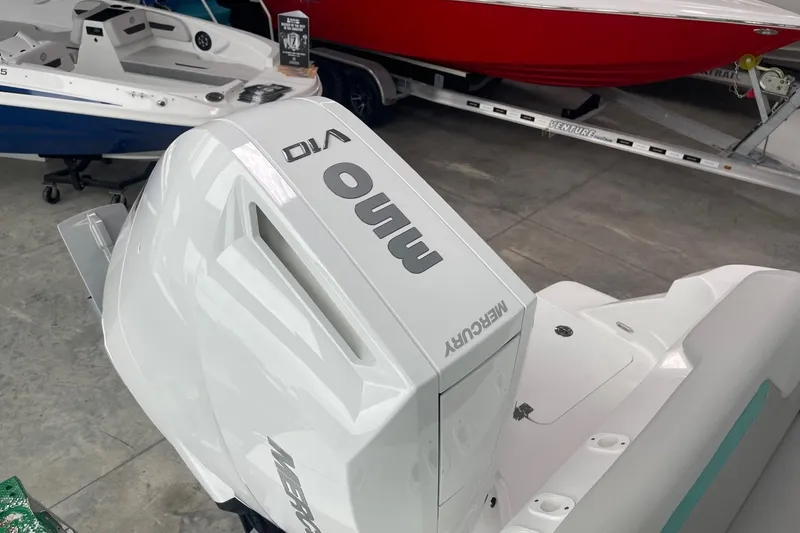 Slide: The Image of 2026 Hurricane Center Console 24 OB with Mercury V10 outboard engine in showroom. - 61