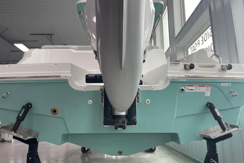 Slide: The Image of 2026 Hurricane Center Console 24 OB boat in showroom, rear view with outboard motor. - 7