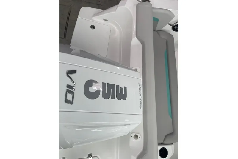 Slide: The Image of 2026 Hurricane Center Console 24 OB with Mercury V10 engine, white and teal interior. - 8