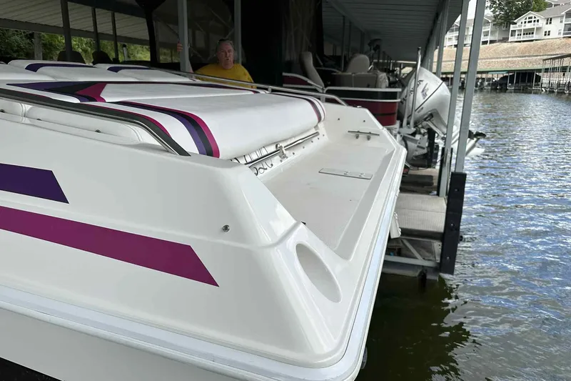 Slide: The Image of 1997 Fountain 29 Fever boat docked with vibrant purple and pink accents. - 11