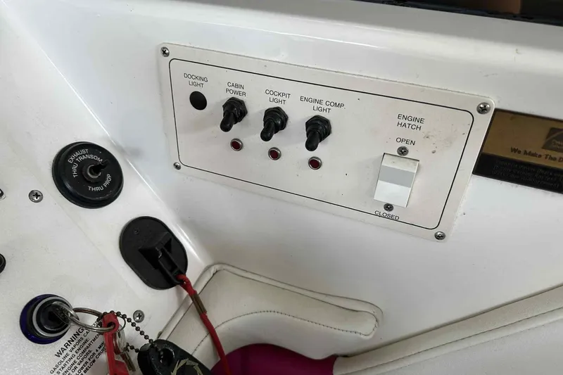 Slide: The Image of Control panel of a 1997 Fountain 29 Fever boat with switches and key ignition. - 12