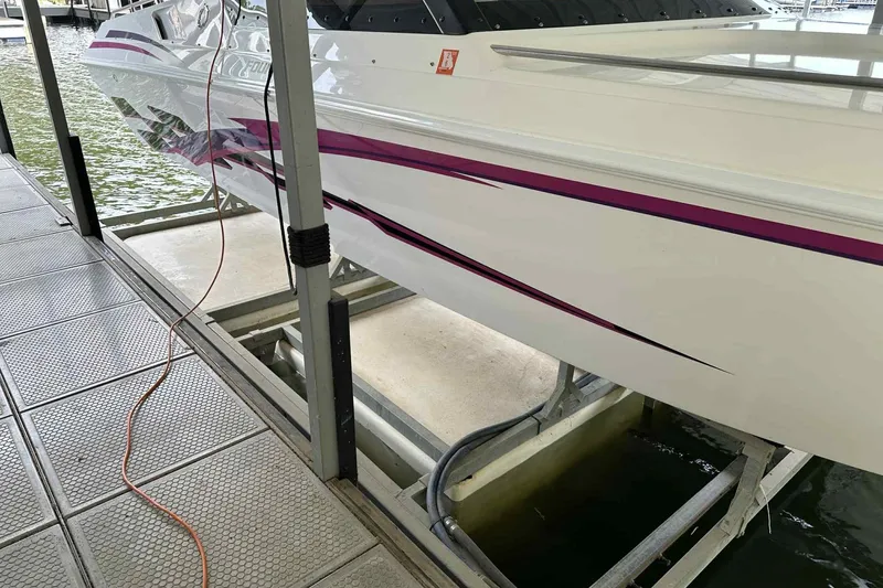 Slide: The Image of 1997 Fountain 29 Fever boat docked, featuring sleek design and vibrant purple accents. - 13