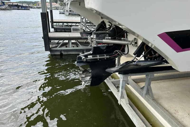 Slide: The Image of 1997 Fountain 29 Fever boat with MerCruiser engine, docked by the water. - 15